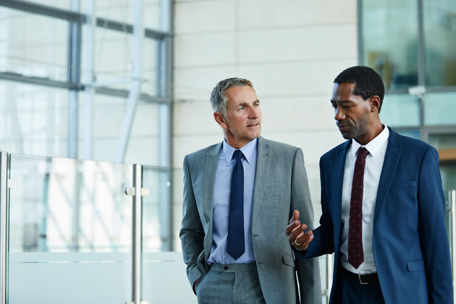 Two business professionals discussing private health insurance options in a modern UK office